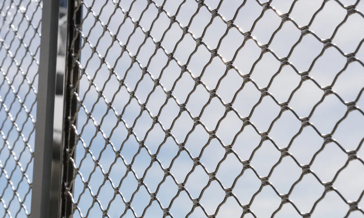 Fine metal security mesh in daylight.